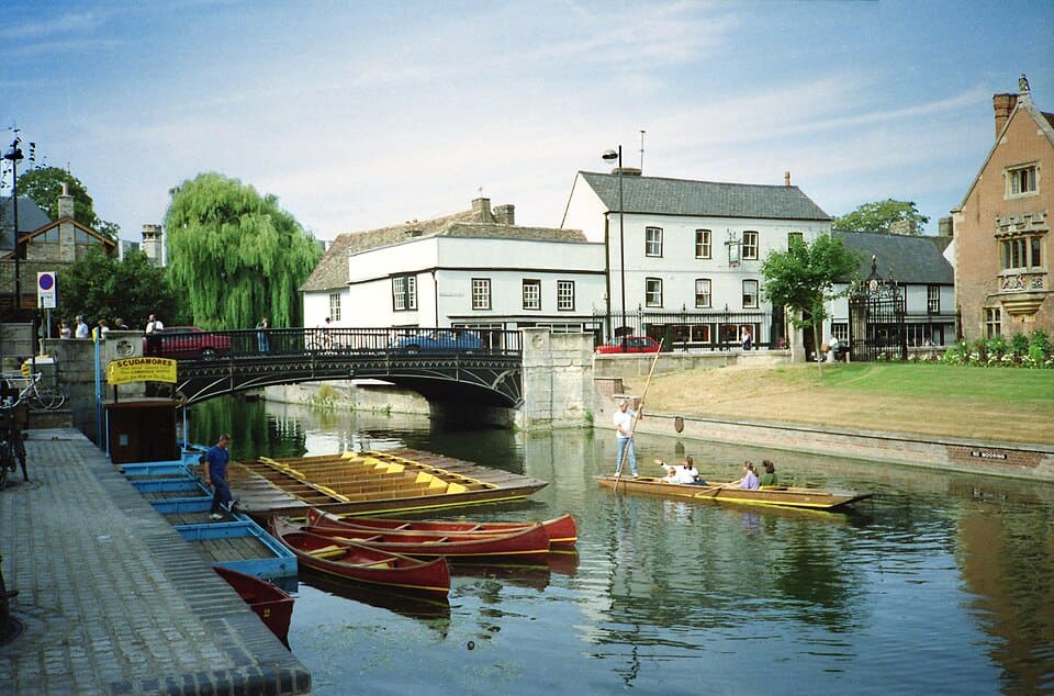 Punts moored on the River Cam beside Magdalene Bridge at Quayside, Cambridge